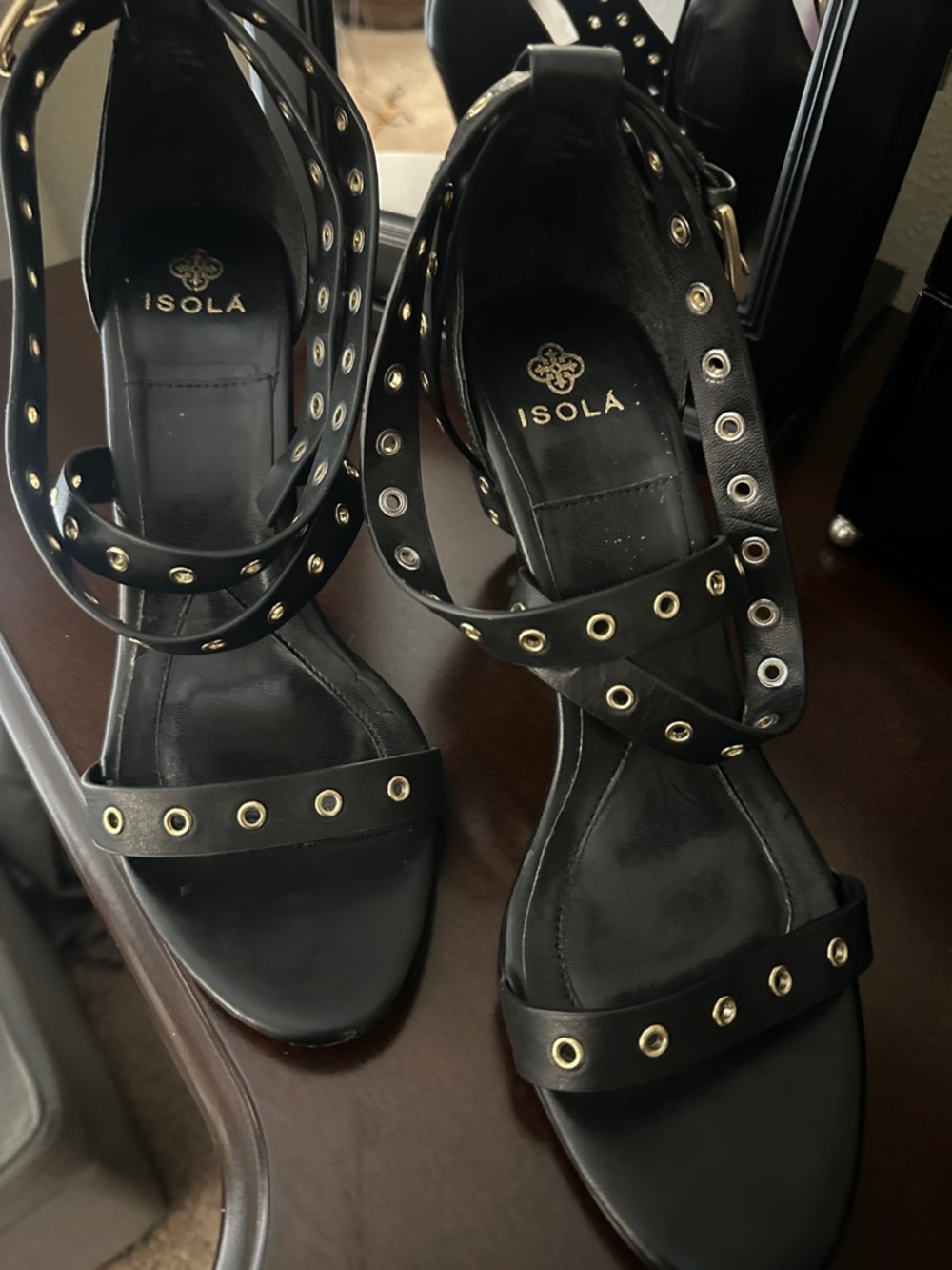 Isola Black Leather Ankle-Strap Sandals with Gold Grommets